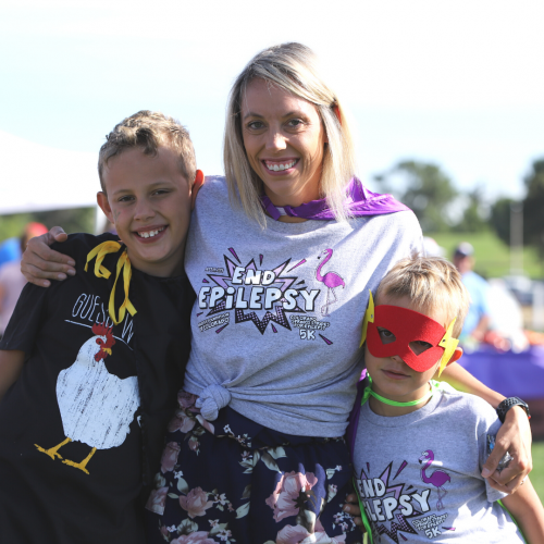 Mom and two children smiling at the Walk to End Epilepsy