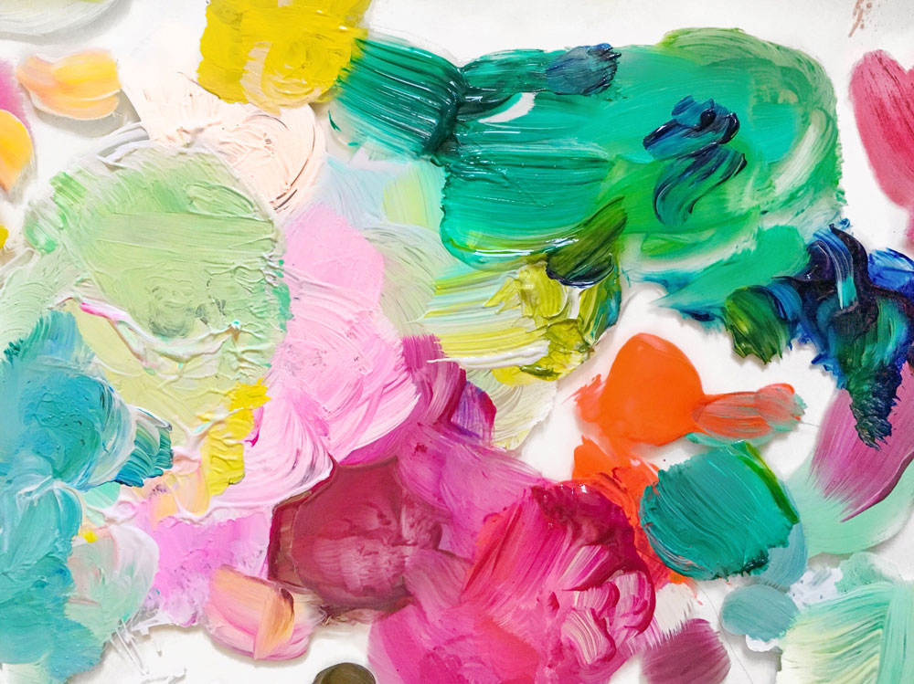 Blobs of different colors of paint on a palette