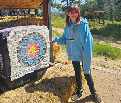 Girl standing next to bulls eye