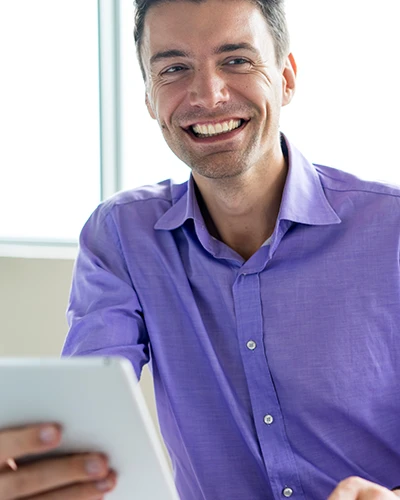 man holding tablet, smiling