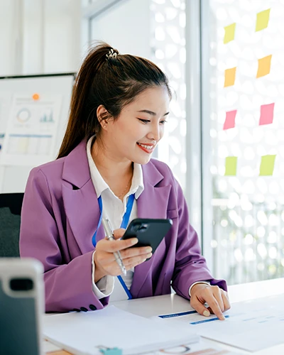 Woman at desk, smiling